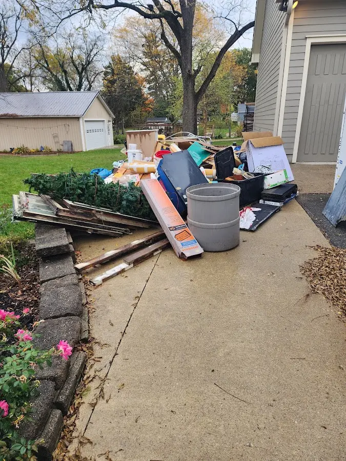 Dumpster being loaded with debris for Estate Cleanout Dumpster Rental in Placentia